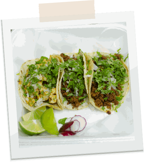 Polaroid of three street tacos with lime and radish